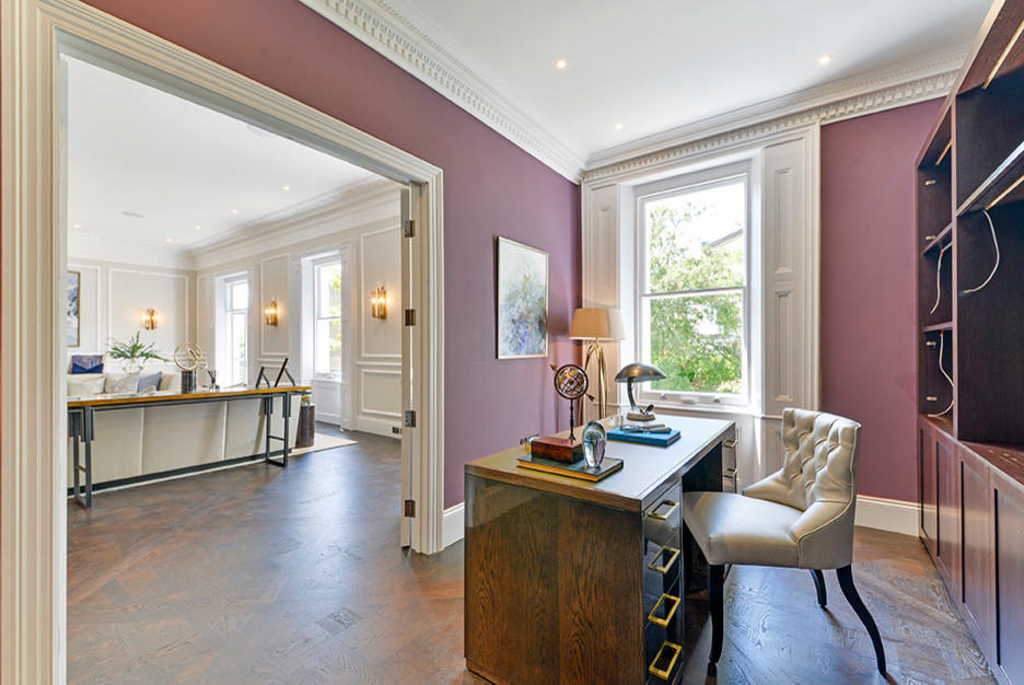 Inspiration for a study room in London with purple walls, medium hardwood floors and a freestanding desk.