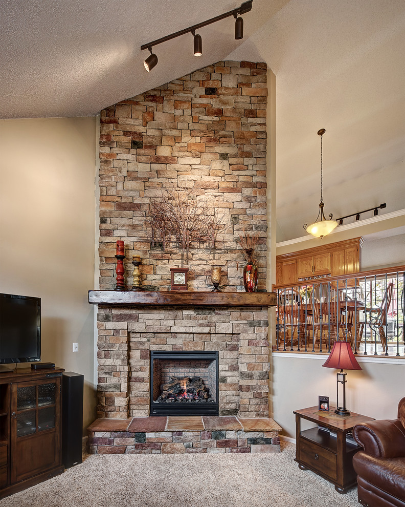 Eclectic formal carpeted and beige floor living room photo in Kansas City with beige walls, a standard fireplace, a stone fireplace and a tv stand