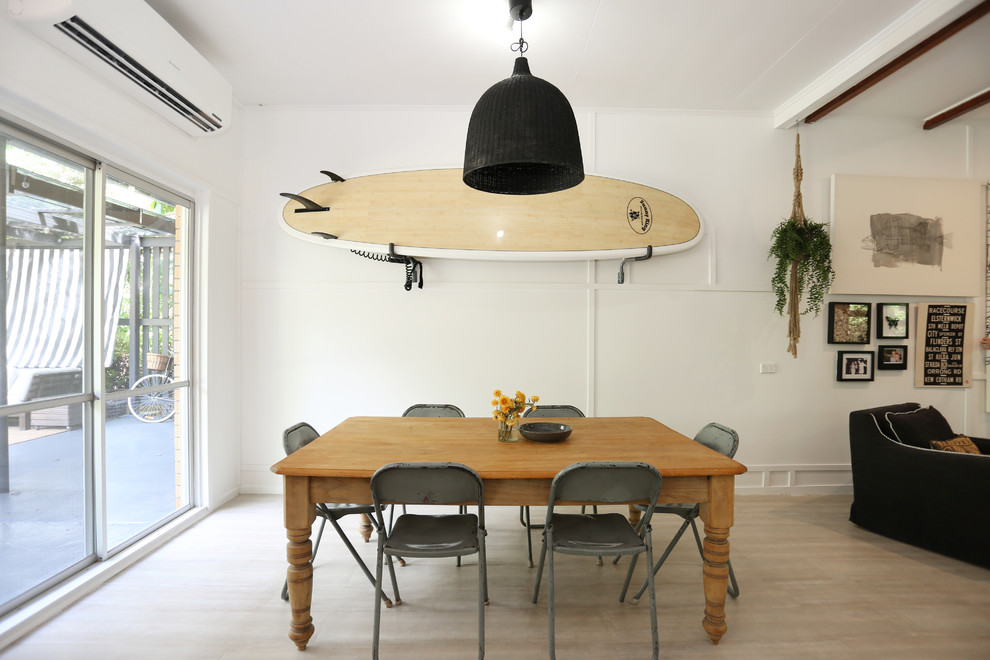 This is an example of a beach style open plan dining in Other with white walls, light hardwood floors and beige floor.