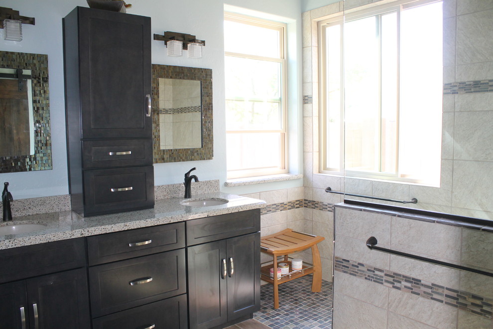 Mid-sized transitional master beige tile and porcelain tile porcelain tile and brown floor walk-in shower photo in Phoenix with flat-panel cabinets, black cabinets, a two-piece toilet, blue walls, an undermount sink and quartz countertops