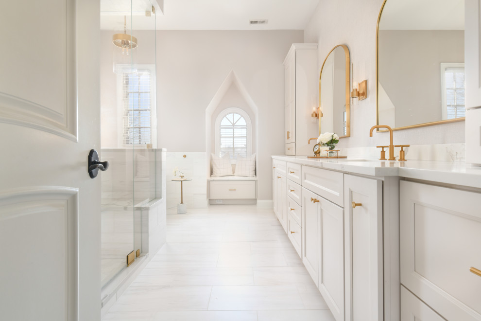 This is an example of a large transitional master bathroom in Chicago with a freestanding tub, a double shower, ceramic tile, beige walls, ceramic floors, an undermount sink, quartzite benchtops, a hinged shower door, white benchtops, a double vanity, a built-in vanity, recessed-panel cabinets, white cabinets, white tile and white floor.
