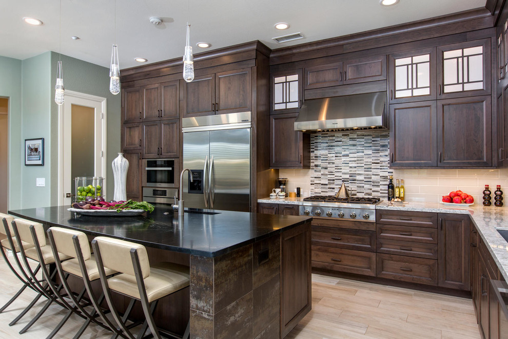 Large transitional l-shaped porcelain tile and beige floor kitchen photo in Denver with an undermount sink, recessed-panel cabinets, medium tone wood cabinets, quartzite countertops, beige backsplash, glass tile backsplash, stainless steel appliances, an island and white countertops
