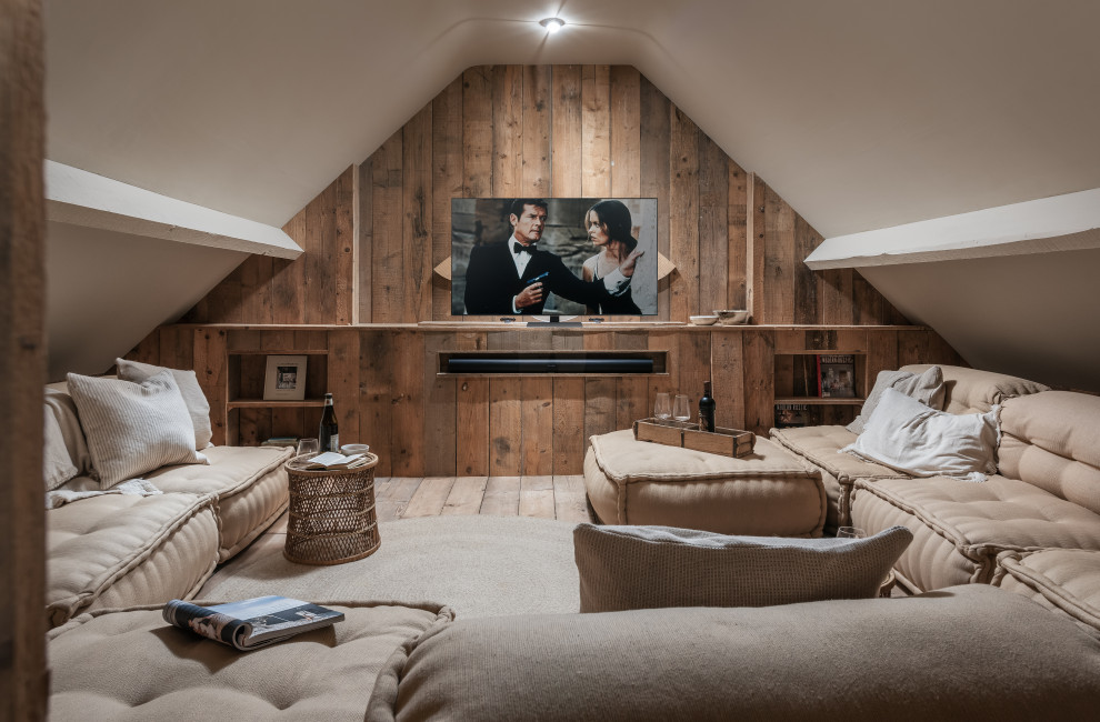 Home theater - mid-sized coastal enclosed medium tone wood floor and brown floor home theater idea in Cornwall with brown walls and a media wall