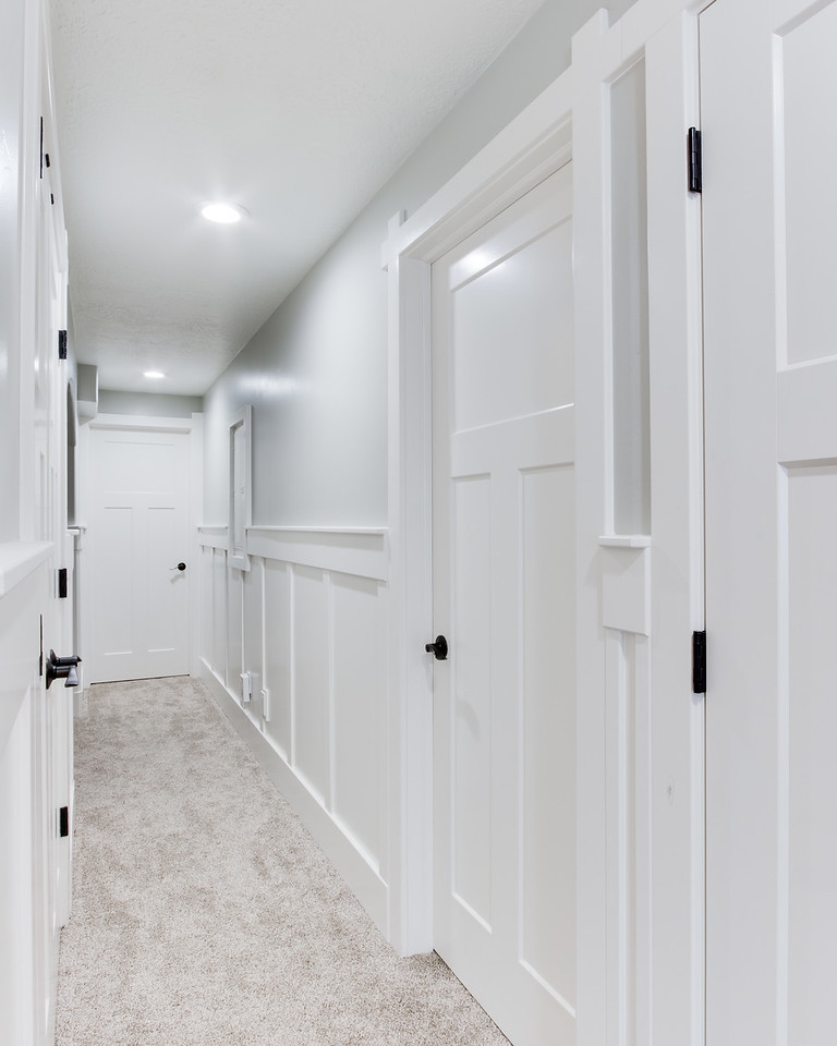 This is an example of a mid-sized transitional hallway in Salt Lake City with grey walls, carpet and beige floor.