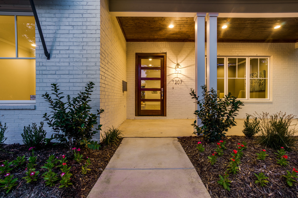 Design ideas for a mid-sized traditional front door in Dallas with white walls, concrete floors, a single front door and a glass front door.