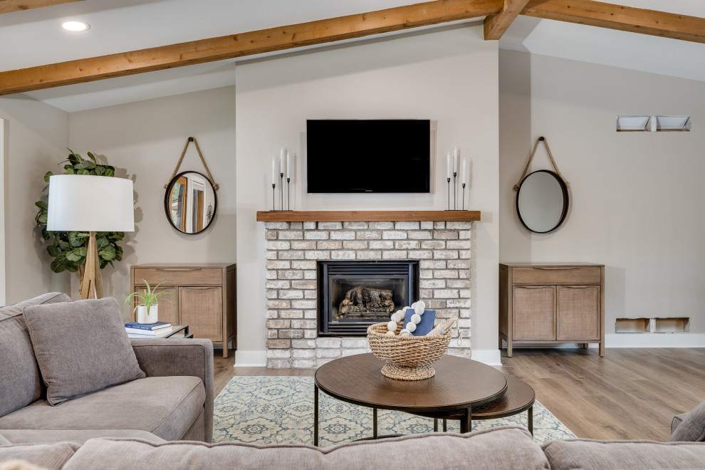 Inspiration for a large open concept living room in Other with beige walls, vinyl floors, a standard fireplace, a brick fireplace surround, a wall-mounted tv, brown floor, exposed beam and wood walls.