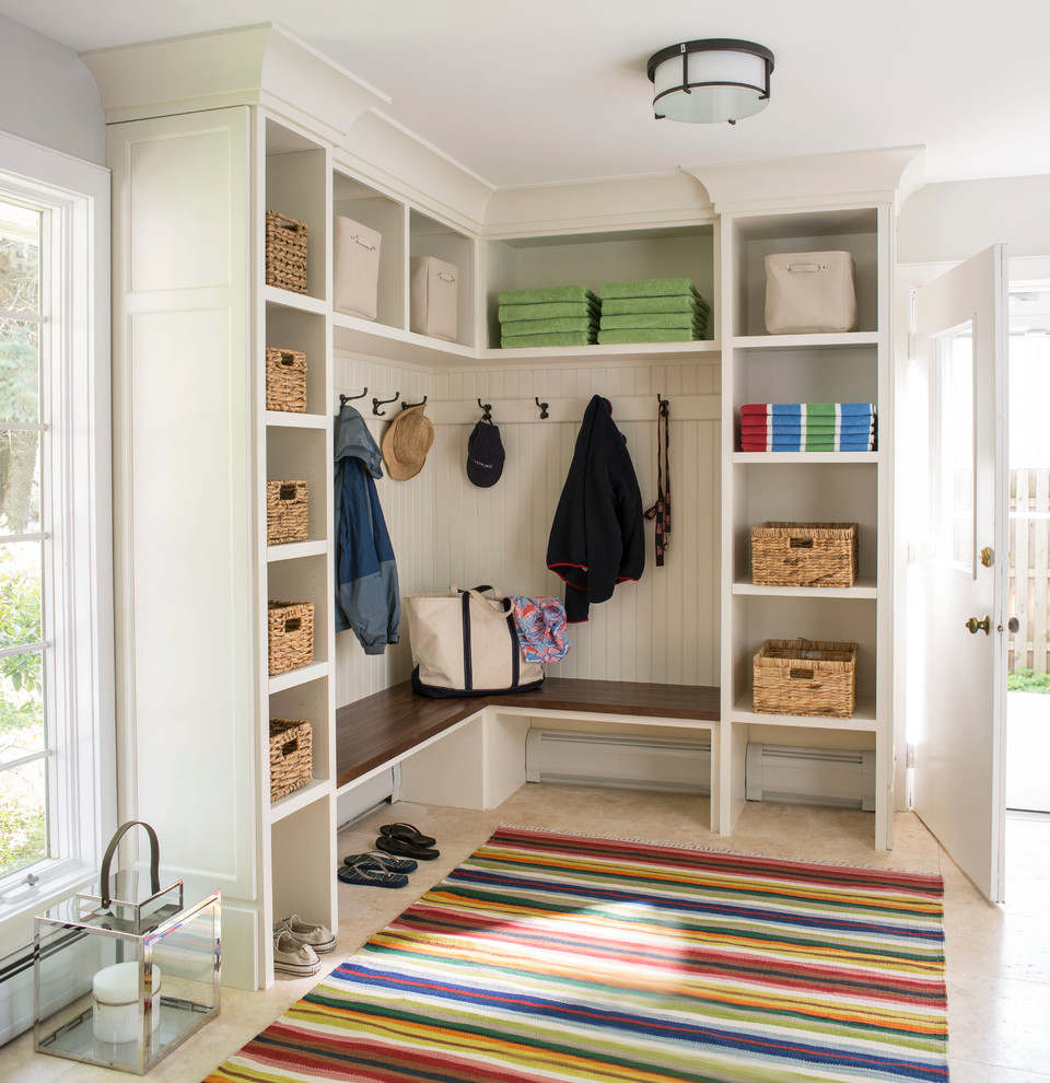 This is an example of a beach style mudroom in New York with white walls, a single front door and a white front door.