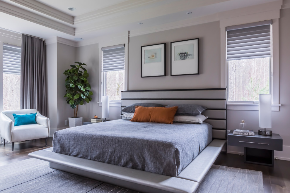 Design ideas for a large contemporary master bedroom in Raleigh with grey walls, dark hardwood floors, no fireplace and brown floor.
