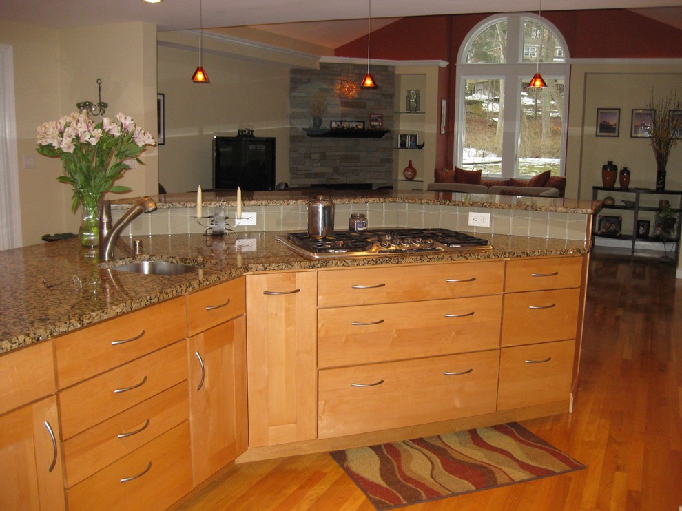 Transitional u-shaped medium tone wood floor eat-in kitchen photo in Boston with an undermount sink, shaker cabinets, light wood cabinets, granite countertops, beige backsplash, glass tile backsplash, stainless steel appliances and an island