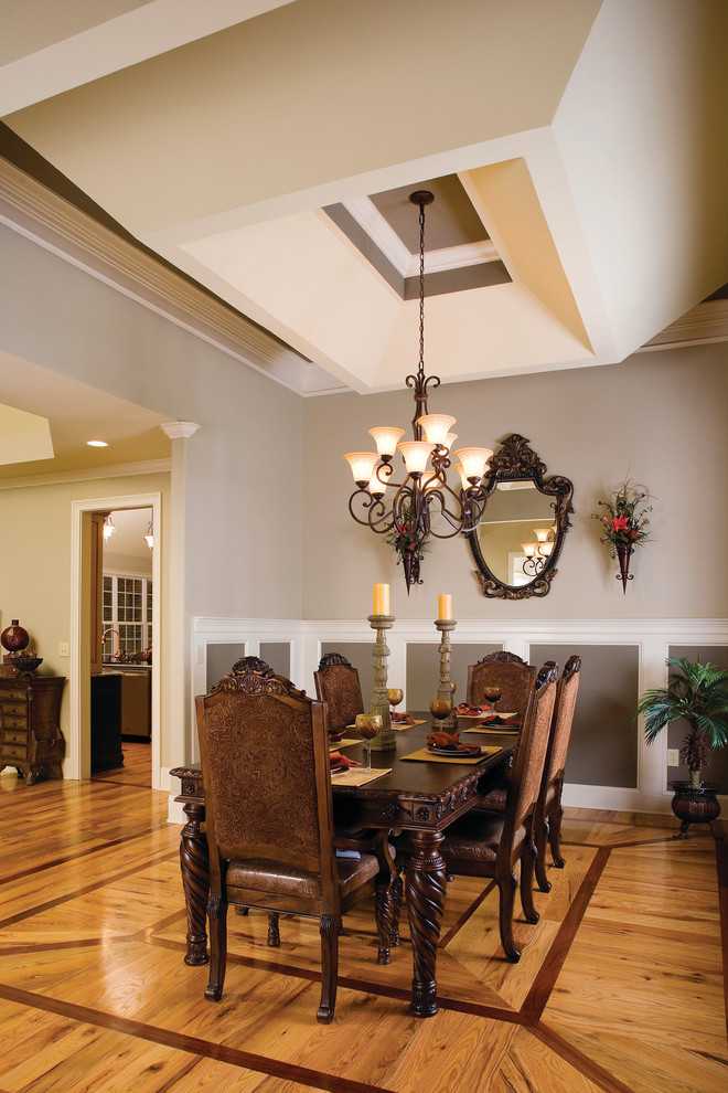 Inspiration for a traditional dining room in Charlotte with grey walls.