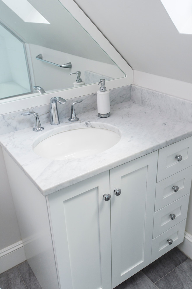 Example of a small transitional master white tile and subway tile ceramic tile alcove bathtub design in Boston with recessed-panel cabinets, white cabinets, a two-piece toilet, white walls, an undermount sink and marble countertops