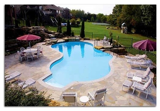 Inspiration for a backyard stone and custom-shaped pool remodel