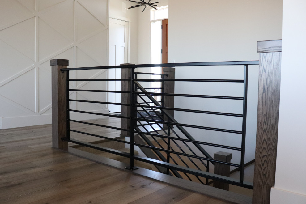 Inspiration for a large transitional l-shaped medium tone wood floor and brown floor open concept kitchen remodel with a single-bowl sink, shaker cabinets, white cabinets, quartz countertops, gray backsplash, subway tile backsplash, stainless steel appliances, an island and white countertops