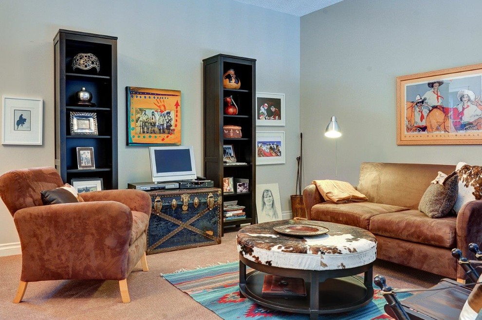 Mid-sized loft-style family room in Calgary with grey walls, carpet and a freestanding tv.