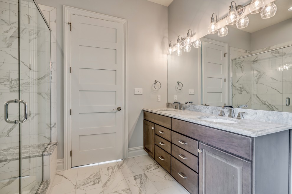 Transitional master gray tile and ceramic tile bamboo floor and brown floor doorless shower photo with raised-panel cabinets, medium tone wood cabinets, a two-piece toilet, gray walls, an undermount sink, granite countertops and gray countertops