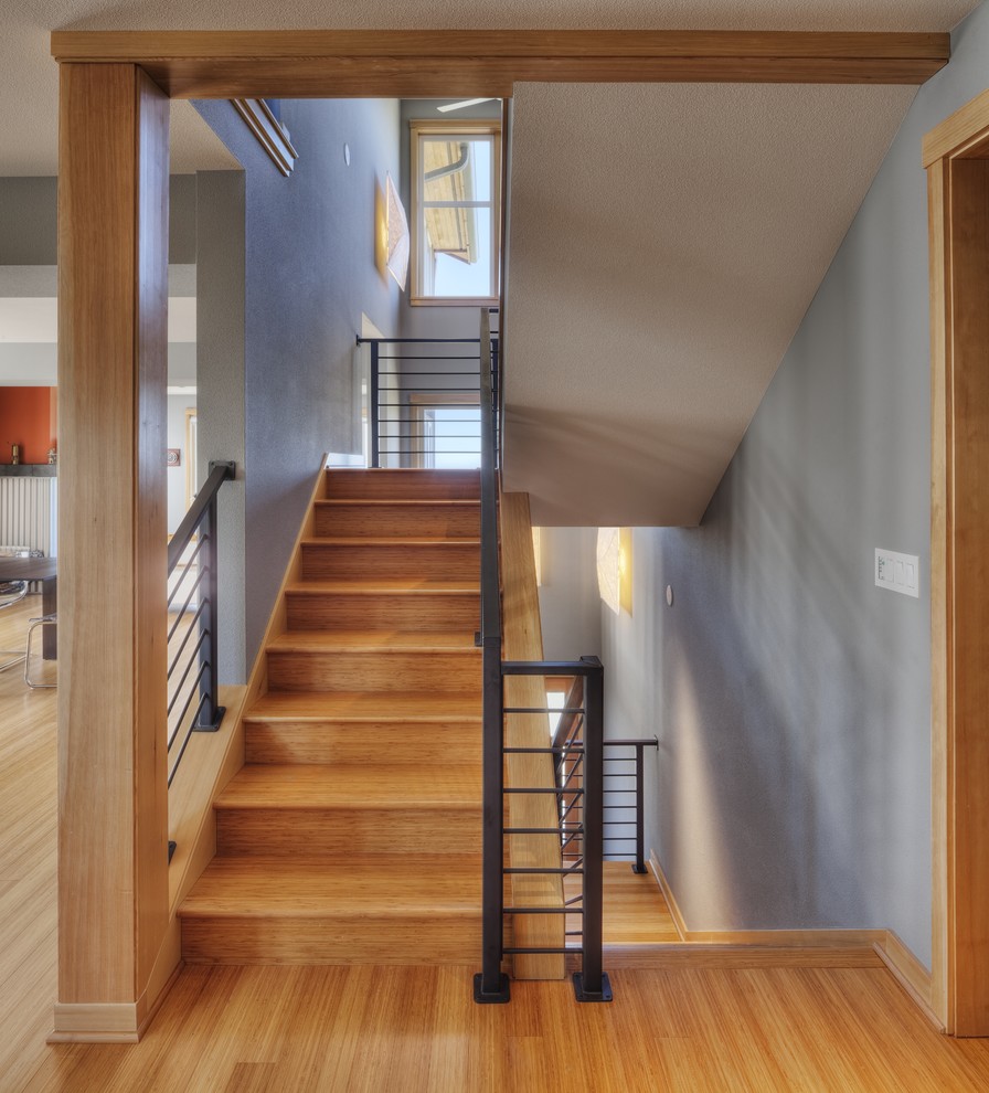 Photo of a contemporary wood u-shaped staircase in Portland with wood risers.