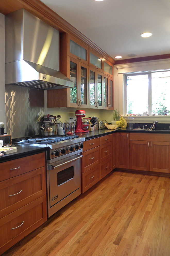 This is an example of an arts and crafts kitchen in Seattle with stainless steel appliances.