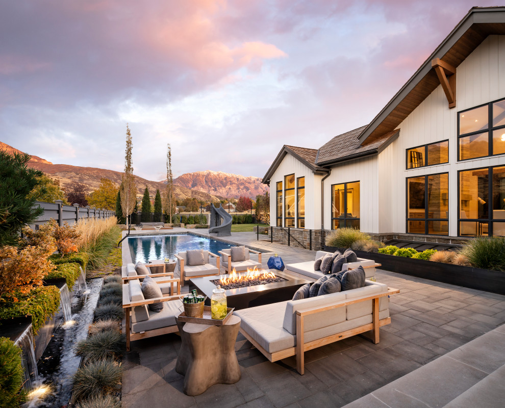 Design ideas for an expansive country backyard patio in Salt Lake City with concrete pavers and no cover.