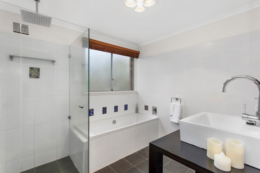 Design ideas for a mid-sized contemporary bathroom in Sydney with a trough sink, open cabinets, dark wood cabinets, a drop-in tub, white tile, ceramic tile and ceramic floors.