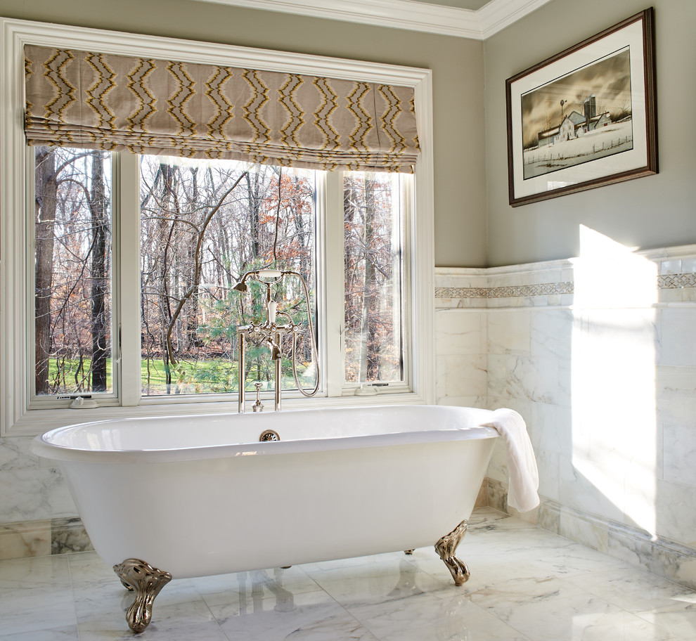 Photo of a large traditional master bathroom in New York with recessed-panel cabinets, green cabinets, a claw-foot tub, a corner shower, a two-piece toilet, white tile, grey walls, marble floors, an undermount sink, marble benchtops and marble.