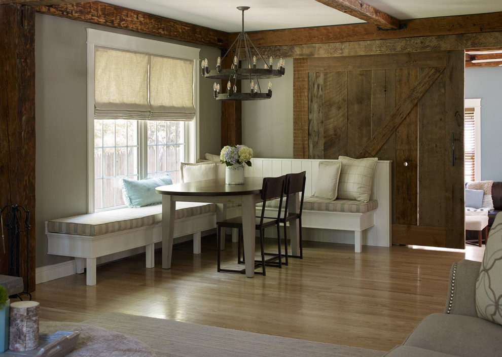 Design ideas for a large country dining room in Portland Maine with beige walls, light hardwood floors and exposed beam.