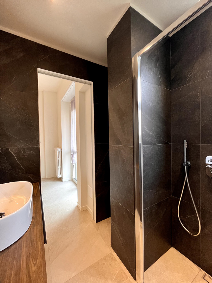 Small trendy black tile and porcelain tile porcelain tile, beige floor and single-sink bathroom photo in Milan with raised-panel cabinets, a two-piece toilet, black walls, a vessel sink, wood countertops, brown countertops and a freestanding vanity