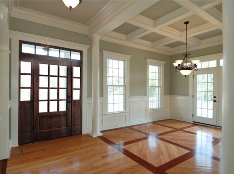 Inspiration for a mid-sized traditional entry hall in Other with green walls, medium hardwood floors, a single front door and a dark wood front door.