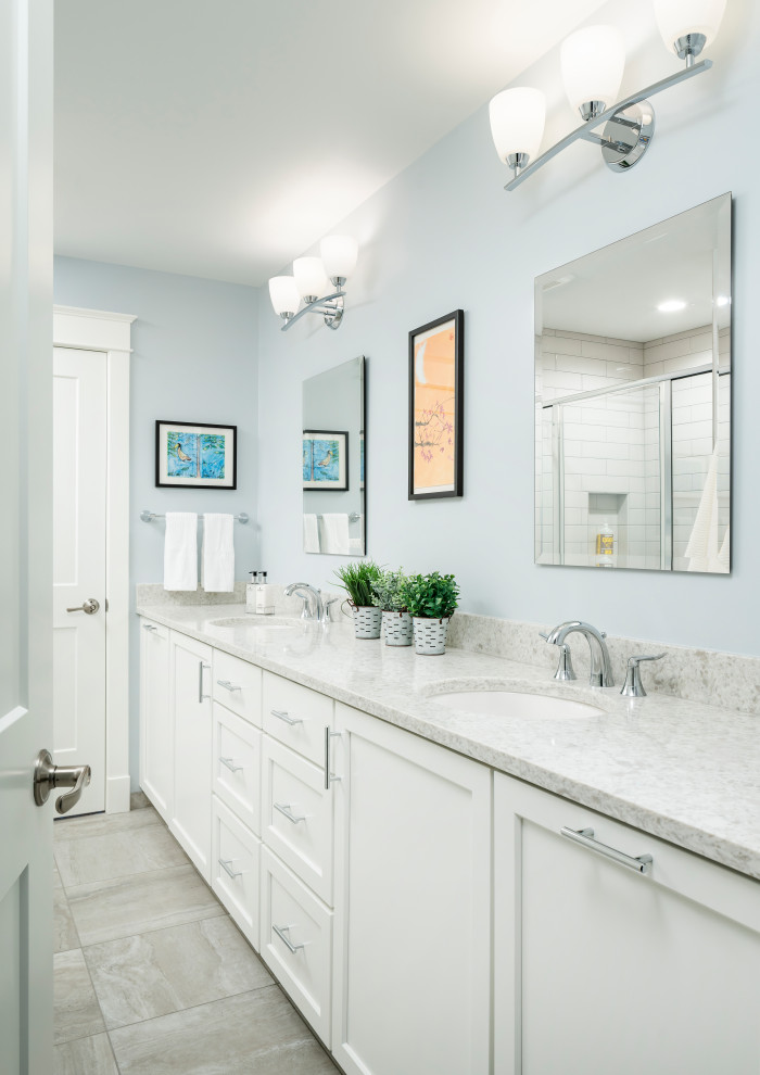 Large transitional kids bathroom in Detroit with shaker cabinets, white cabinets, a freestanding tub, an alcove shower, a two-piece toilet, beige tile, porcelain tile, blue walls, porcelain floors, an undermount sink, engineered quartz benchtops, grey floor, a hinged shower door and grey benchtops.