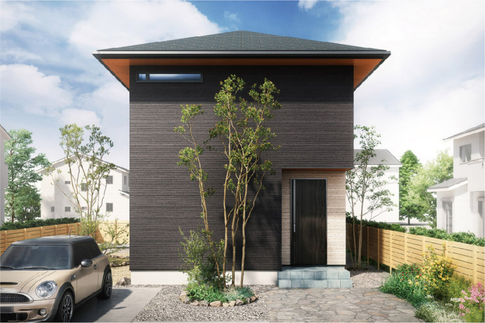 This is an example of a small two-storey black house exterior in Other with a hip roof and a black roof.