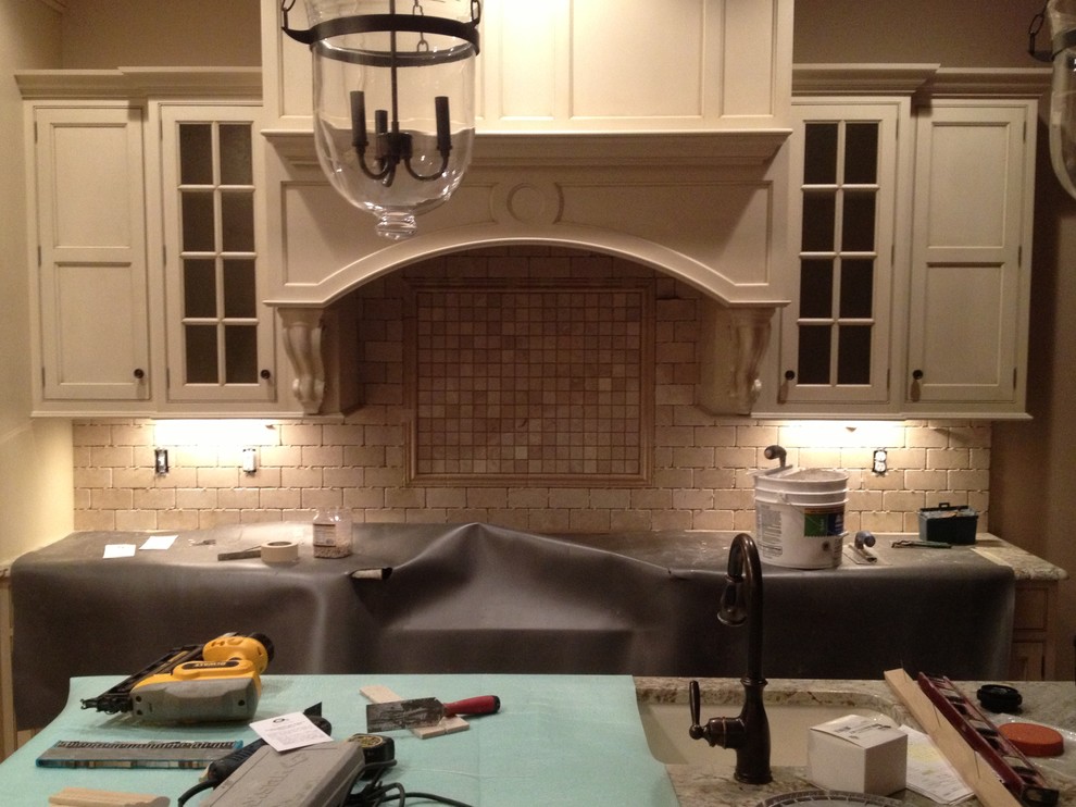 Inspiration for a mid-sized u-shaped eat-in kitchen remodel with a double-bowl sink, white cabinets, beige backsplash, ceramic backsplash and an island