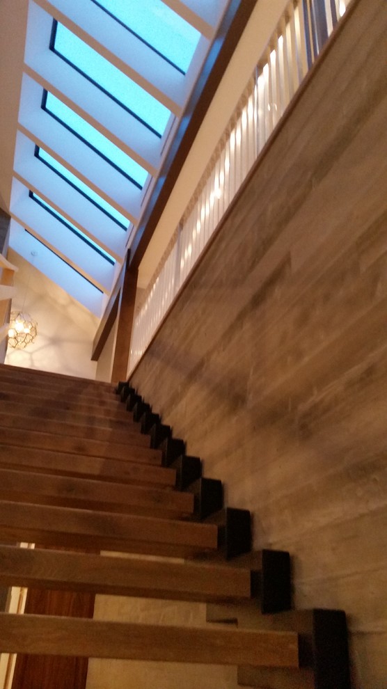 Inspiration for a large modern wood straight staircase in Vancouver with open risers.