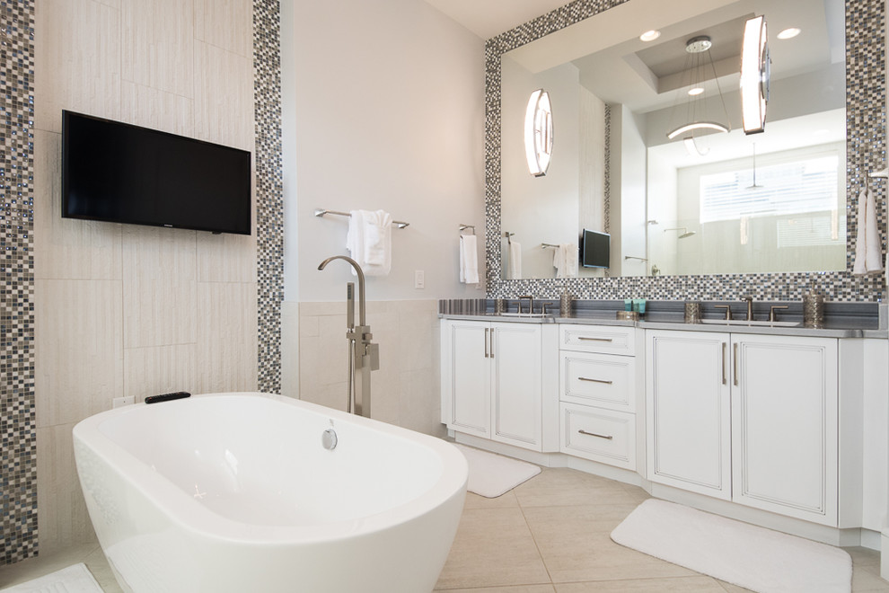 Design ideas for an expansive transitional master bathroom in Orlando with recessed-panel cabinets, white cabinets, a freestanding tub, an open shower, a one-piece toilet, black and white tile, mosaic tile, white walls, porcelain floors, a drop-in sink and marble benchtops.