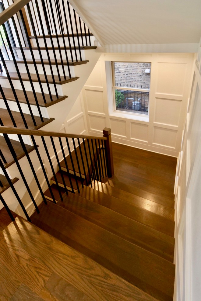 Mid-sized transitional wood u-shaped staircase in Chicago with wood risers and mixed railing.