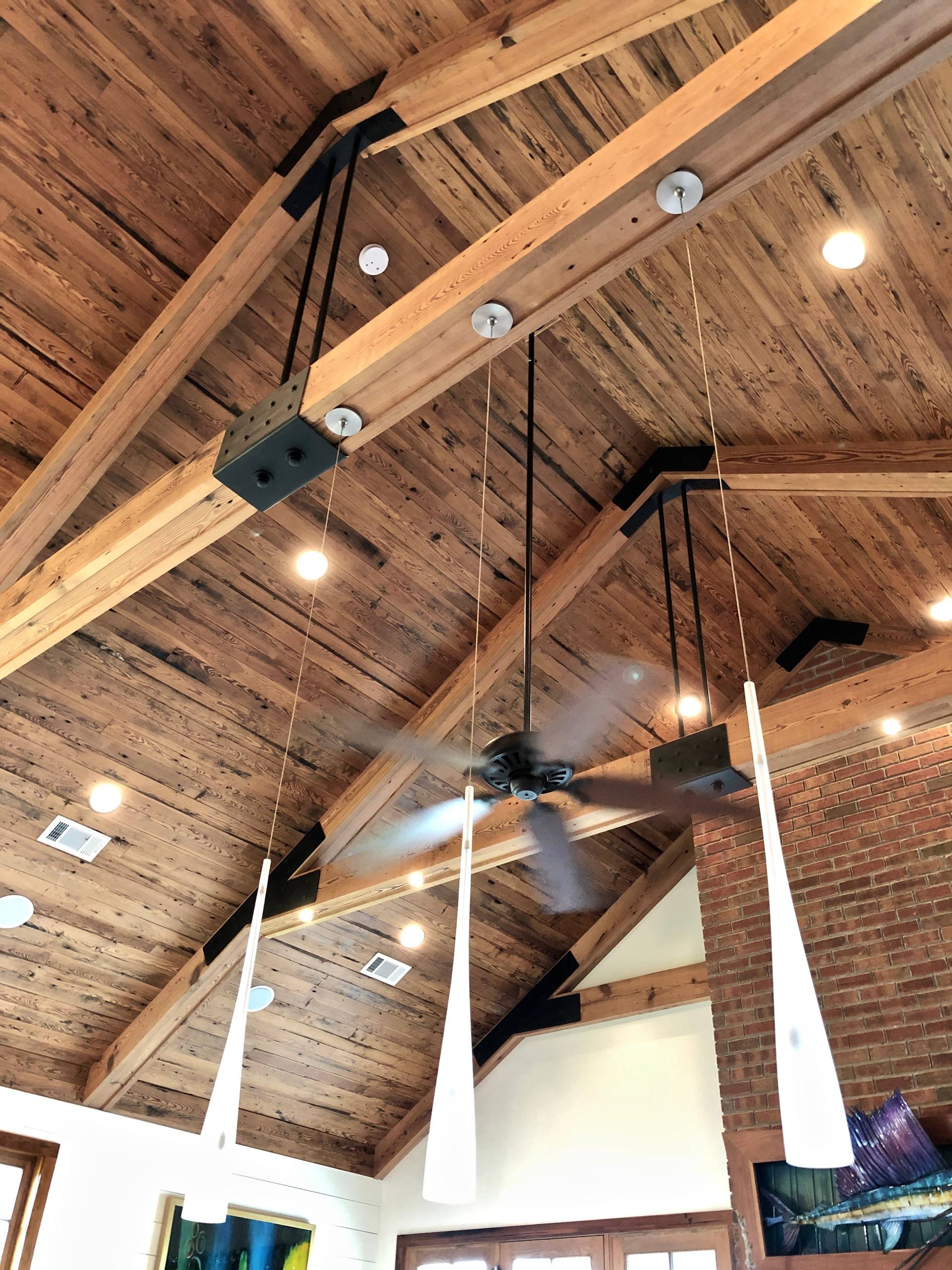 Custom designed lighting hanging from beams