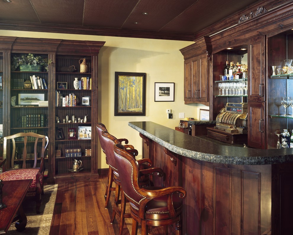 This is an example of a large traditional wine cellar in Denver with medium hardwood floors.