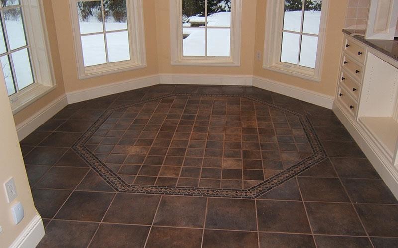 Example of a ceramic tile dining room design with beige walls