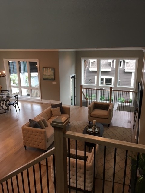 Home design - huge transitional open concept light wood floor and beige floor home design idea in Chicago with beige walls, a standard fireplace, a wood fireplace surround and a wall-mounted tv