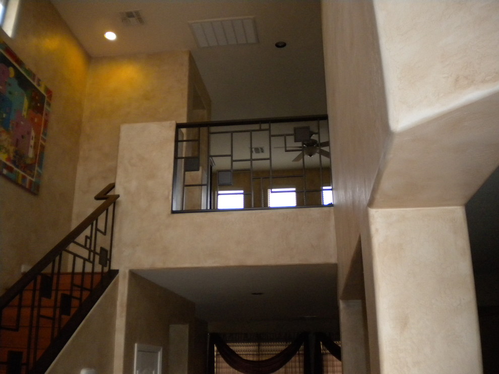 Large transitional wood straight staircase in Phoenix with wood risers.