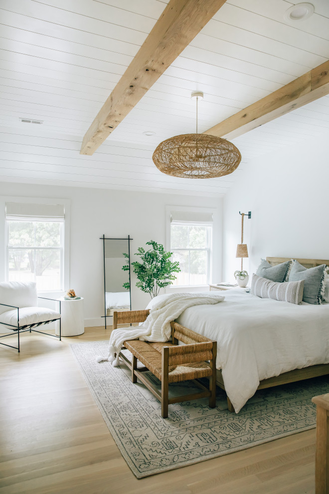 Inspiration for a large coastal master bedroom in Other with white walls, light hardwood flooring, no fireplace, brown floors, exposed beams and tongue and groove walls.
