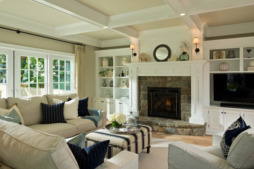 Traditional living room in New York with beige walls and a stone fireplace surround.