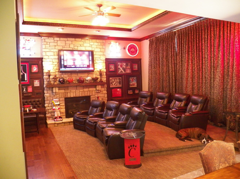 Photo of a large traditional enclosed home theatre in Cincinnati with a wall-mounted tv.