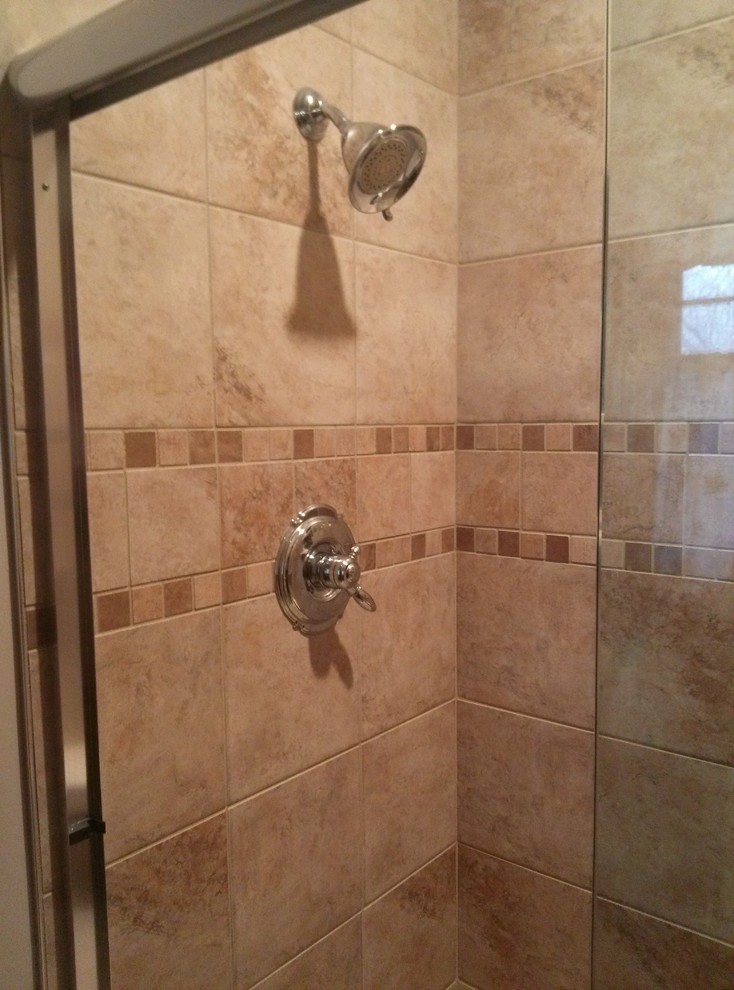 Photo of a small traditional 3/4 bathroom in Indianapolis with an alcove shower, beige tile, travertine, beige walls, travertine floors, beige floor and a sliding shower screen.