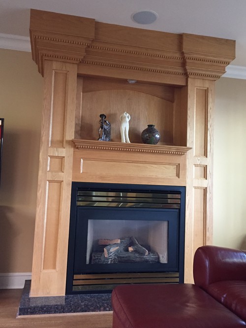 I need help on ideas of how to update this custom wood fireplace surround on a budget.  I really don
