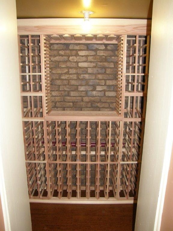 This is an example of a large traditional wine cellar in Minneapolis with dark hardwood floors, storage racks and brown floor.
