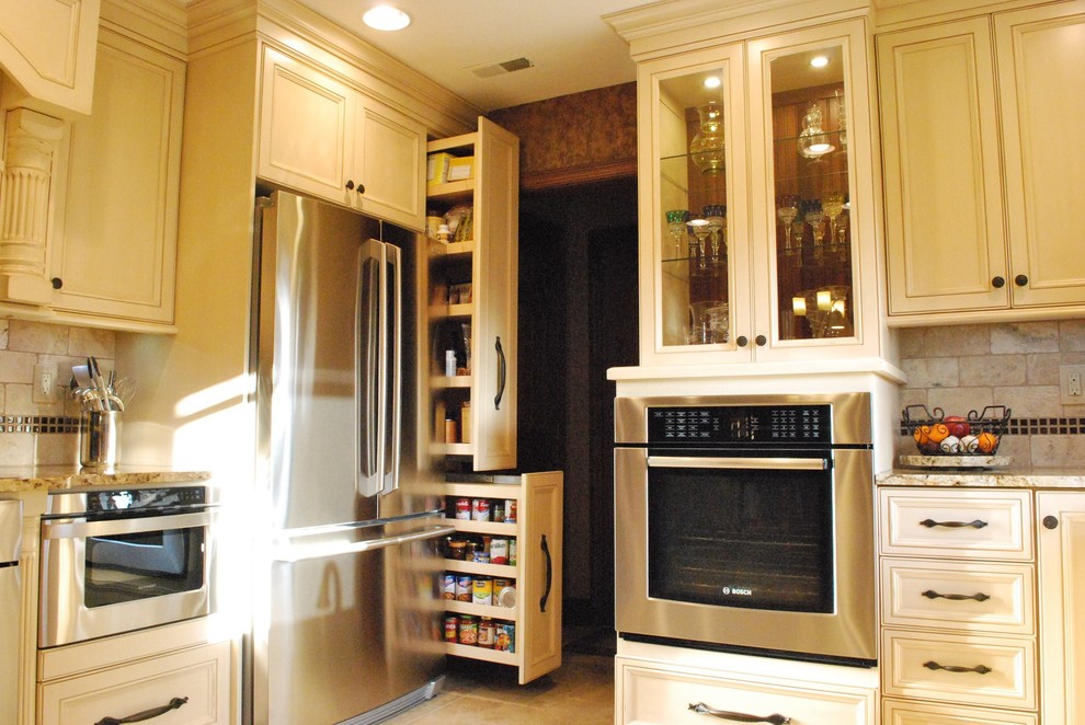 Mid-sized u-shaped eat-in kitchen photo with beaded inset cabinets, beige cabinets, granite countertops, brown backsplash, stone tile backsplash, stainless steel appliances and no island