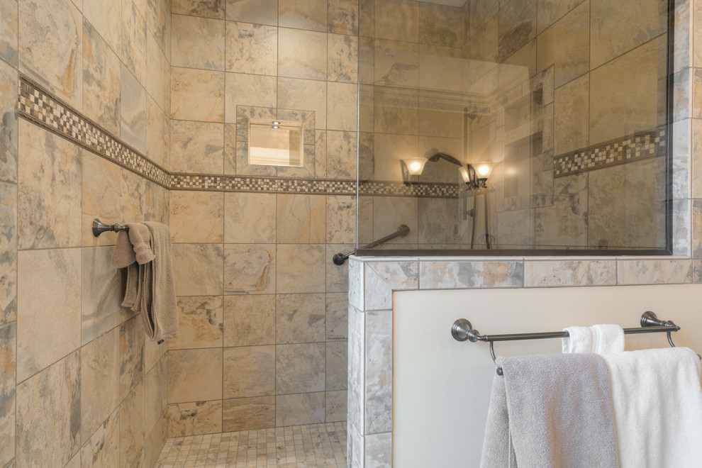 Mid-sized transitional master multicolored tile ceramic tile doorless shower photo with raised-panel cabinets, beige cabinets, a two-piece toilet, beige walls, an undermount sink and quartz countertops