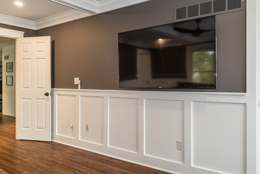 Inspiration for a large transitional master bedroom in St Louis with brown walls, medium hardwood floors, no fireplace, brown floor, coffered and decorative wall panelling.