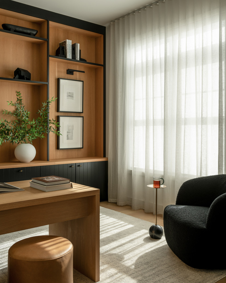 Small trendy built-in desk light wood floor and brown floor study room photo in DC Metro with white walls