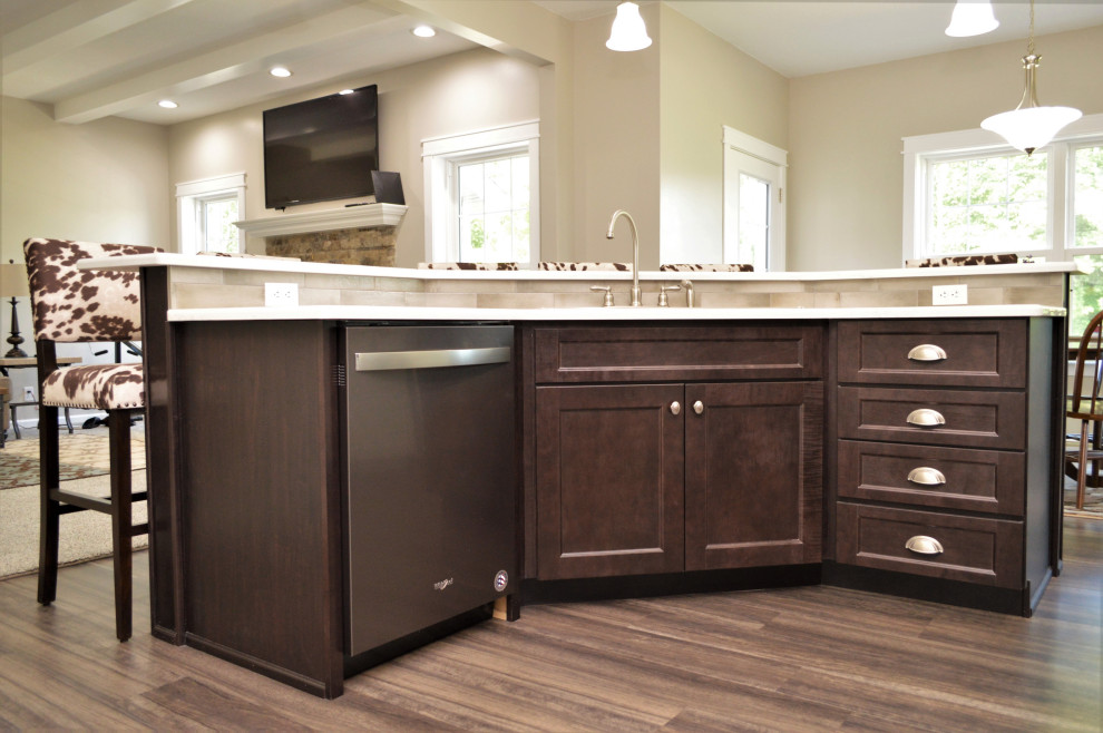 Mid-sized transitional single-wall open concept kitchen photo with a drop-in sink, shaker cabinets, white cabinets, quartzite countertops, beige backsplash, stainless steel appliances, an island and white countertops