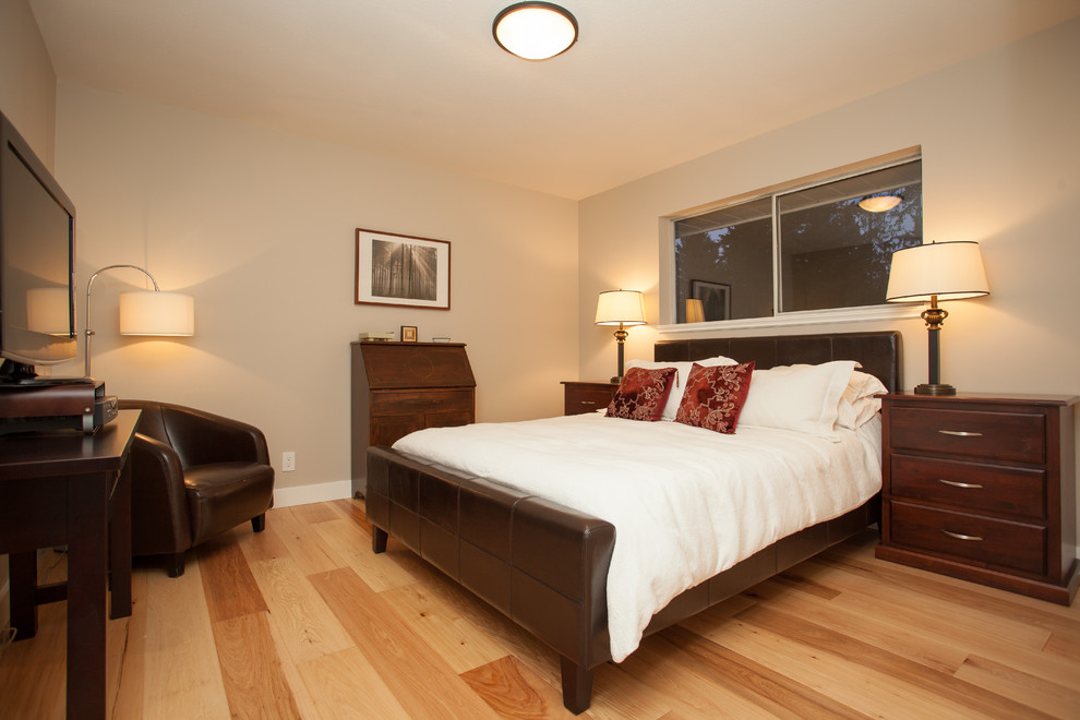 Inspiration for a traditional master bedroom in Vancouver with light hardwood floors.